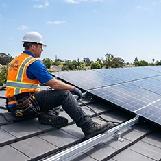 Technician performing solar system maintenance on a Rockingham rooftop